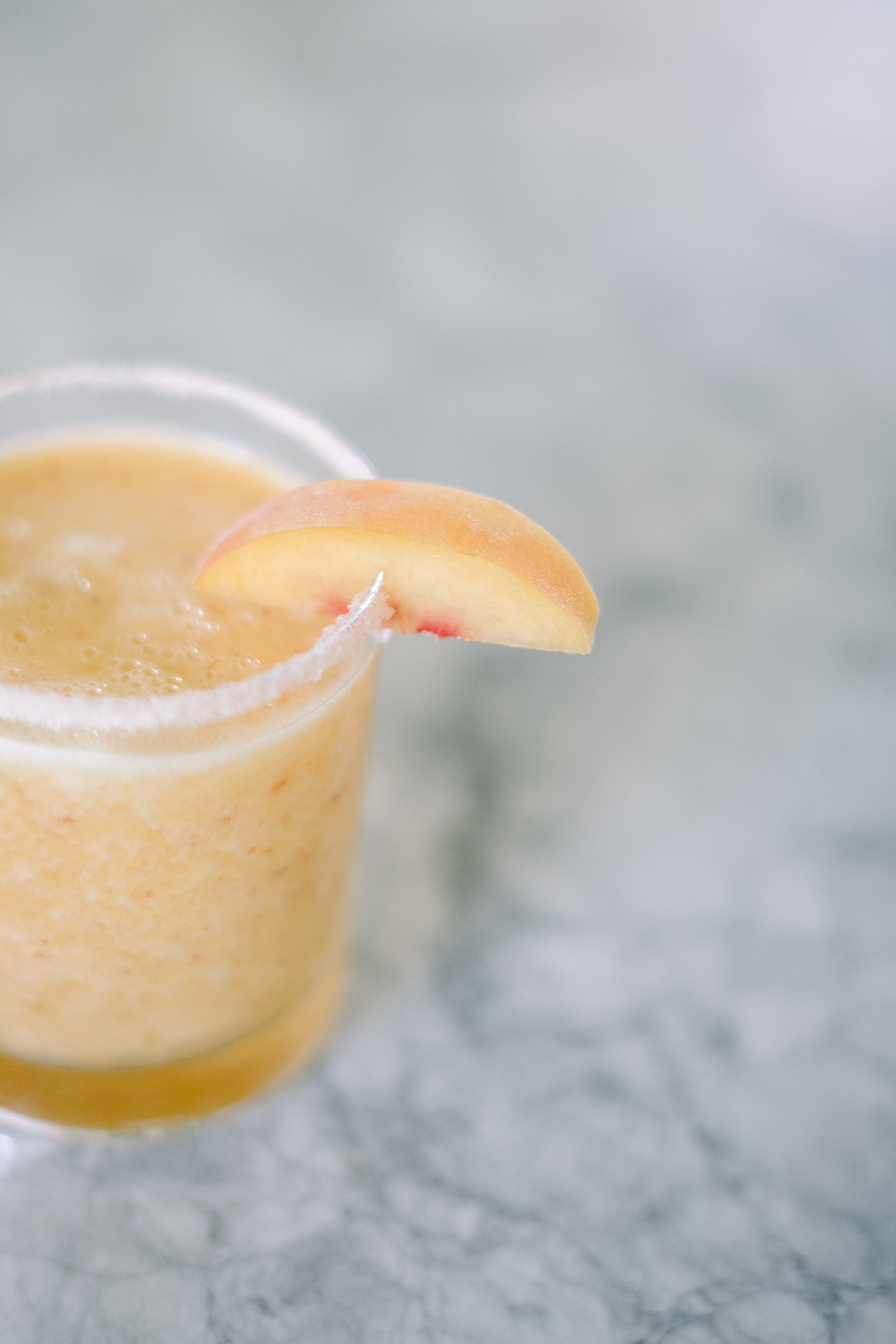 Peach margarita recipe with lime juice, perfect on the rocks or blended. Easy, simple and fresh with peaches and La Croix. Easy Peach Margaritas.